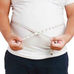 The fat man, the belly is very big, standing using the tape meas