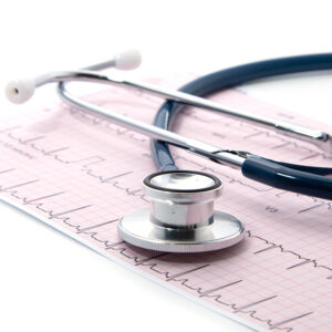 Blue Stethoscope on electrocardiogram (ECG) chart paper